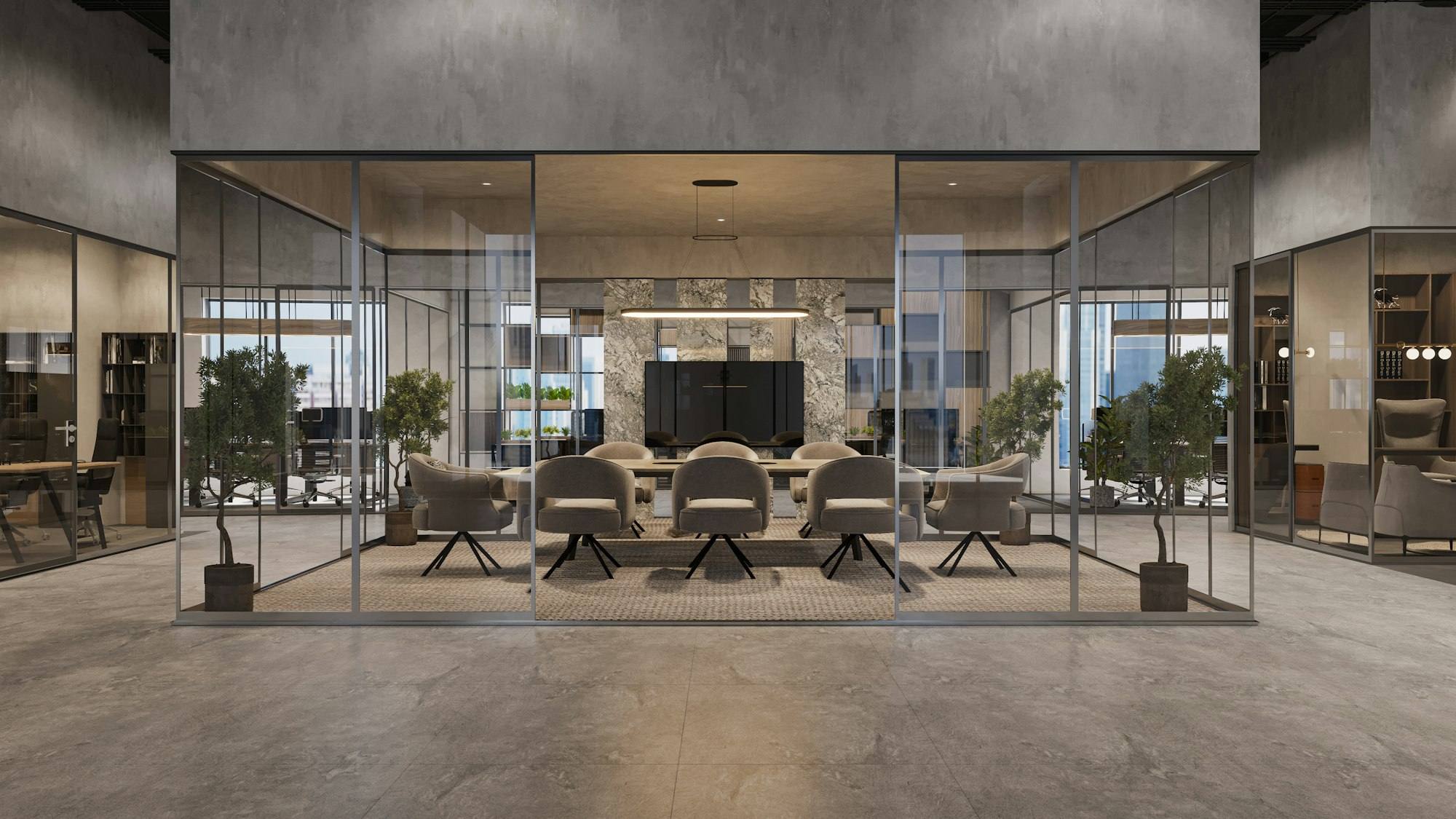 Salle de réunion vitrée avec fauteuils gris autour d'une table et écran mural, bureaux à Saint-Brieuc