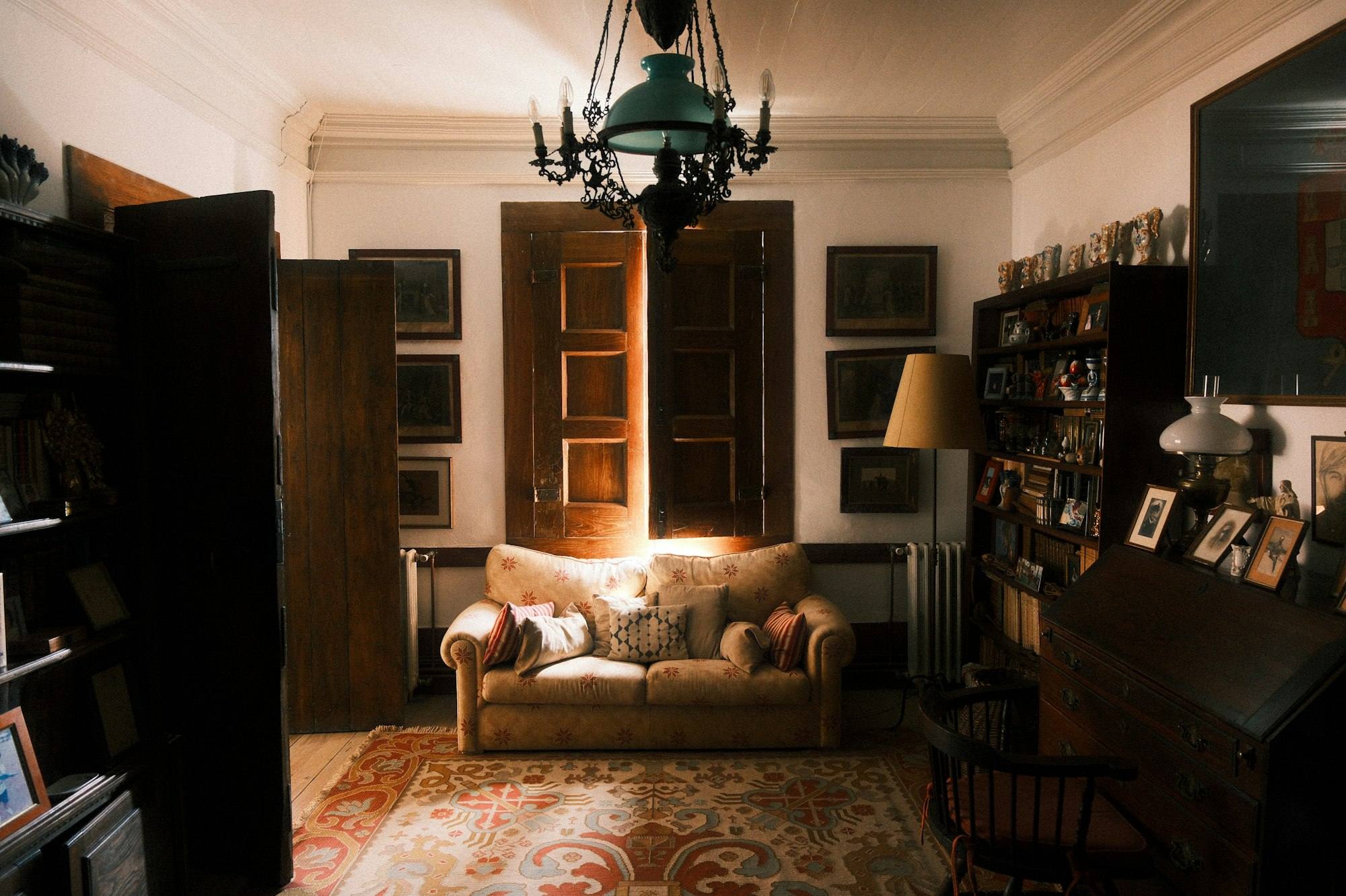 Salon cosy aux meubles anciens et bibliothèque garnie, gîte de caractère près de Vitré
